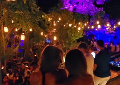 Nightclub in Zakynthos island, a crowd of people enjoying their drinks and dancing to happy music