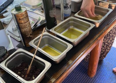 A selection of Olive Oil from the Aristeon Olive press museum and people are tasting different kinds of oil as they have learnt the procedure in the methods. The Olive press uses.