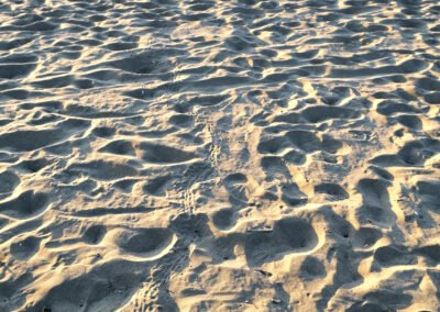 extreme close up of sand on a field and fieldland with grass in the background and a blue sky in Zakynthos Kalamaki Beach