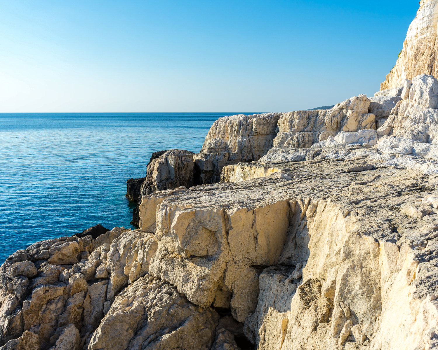 Greece, Zakynthos, Blue ocean behind white rocks of cape plakaki
