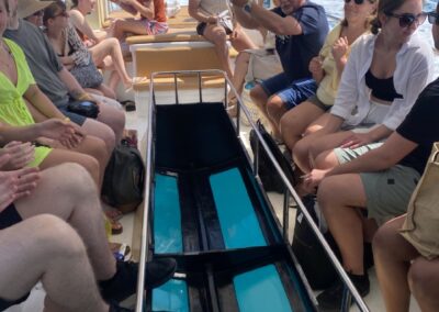 Tourists on a glass bottom boat in search of sea turtles and other marine life in the Ionian sea off the coast of Zakynthos.