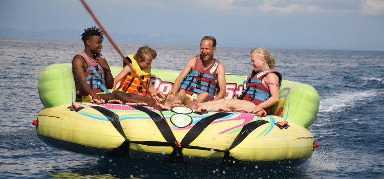 Crazy sofa water sport in Zakynthos island. A happy family enjoying the adrenaline rush in Zakynthos island on a crazy sofa