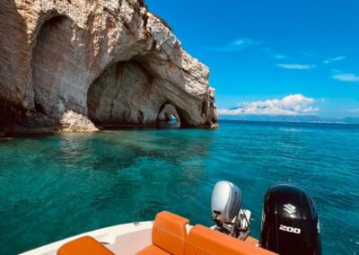 The stern of a comfortable boat stopping for a swim in front of the Zakynthos Blue Caves.