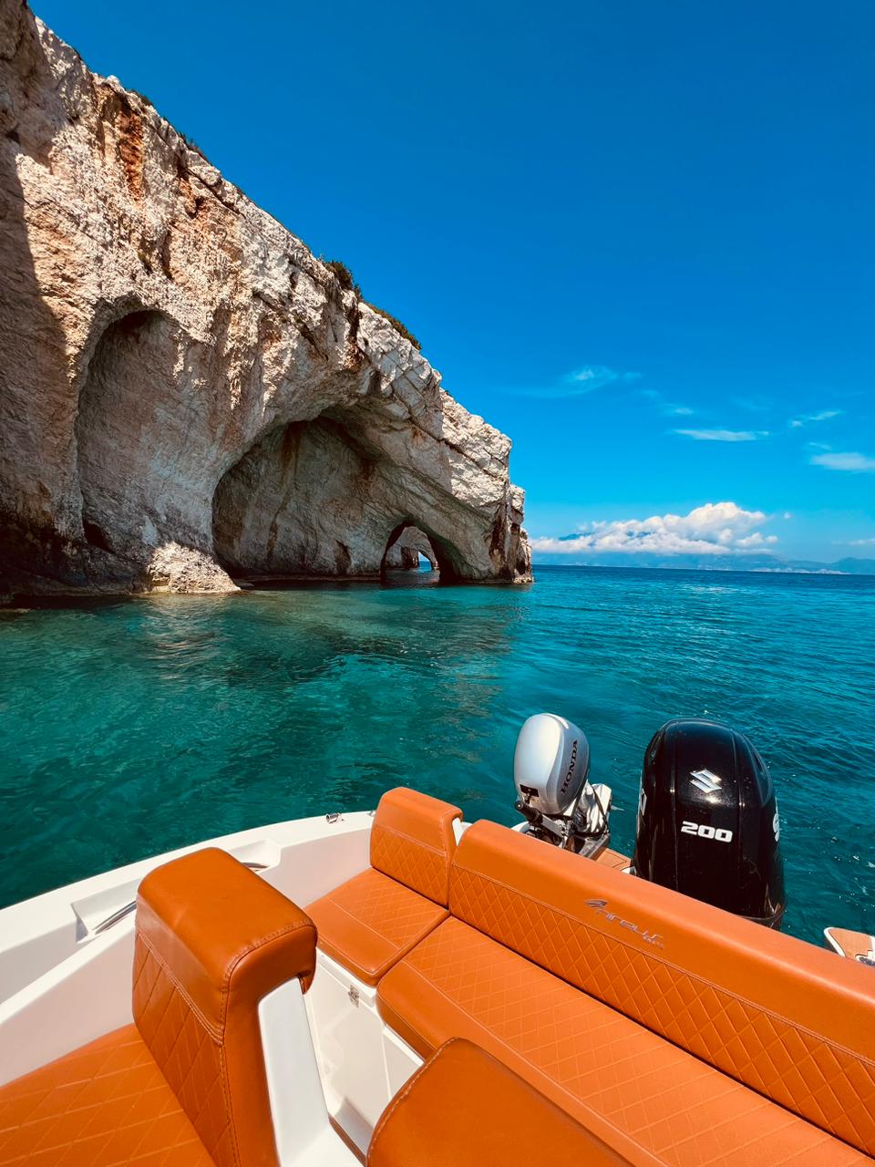 The stern of a comfortable boat stopping for a swim in front of the Zakynthos Blue Caves.