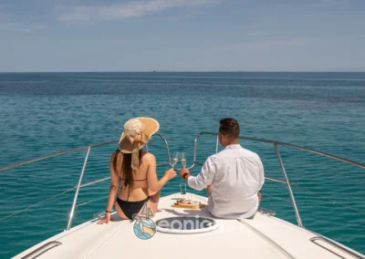 A couple in the front of Princess V55 Yacht in Zakynthos Island