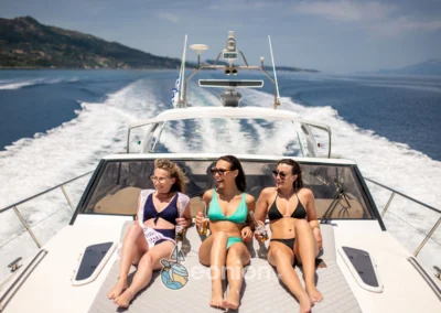 A group of girls sunbathing on Princess V55 Yacht in Zakynthos Island