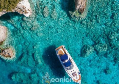 Drone footage top view of the Cranchi 50 Yacht in the turquoise Ionian Sea waters